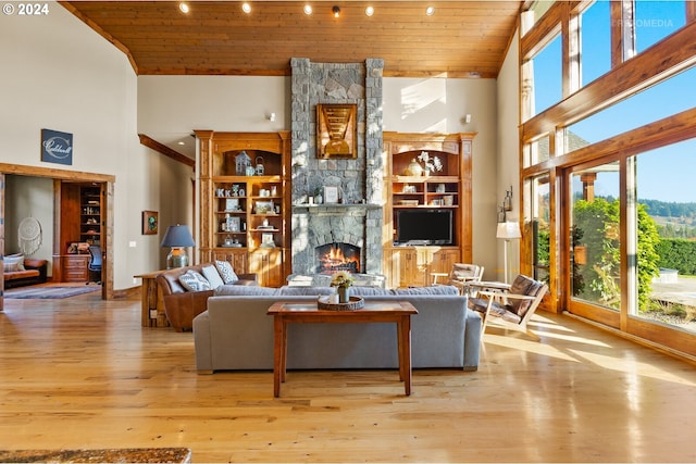 2945 SW Homesteader Rd, West Linn, OR 97068 - living area with high vaulted ceiling, wood ceiling, wood finished floors, and a fireplace
