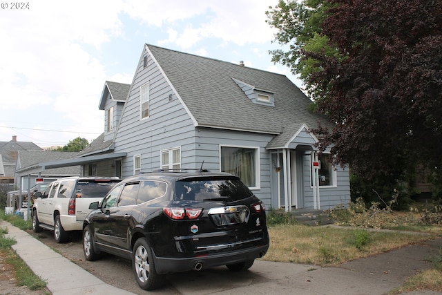 view of front facade featuring roof with shingles