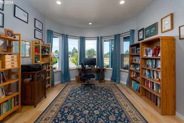 home office with light hardwood / wood-style floors