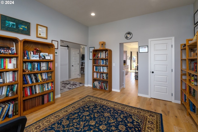 living area featuring light hardwood / wood-style floors and a barn door