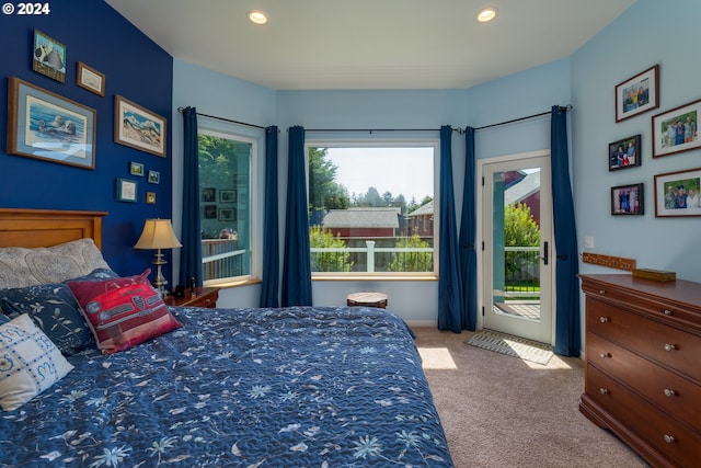 bedroom featuring light carpet and access to exterior