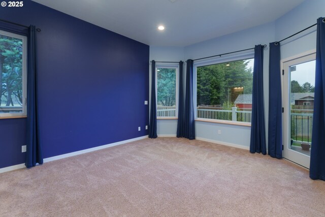 spare room featuring carpet, baseboards, and recessed lighting