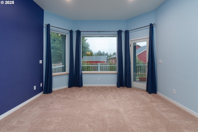 empty room with carpet floors and baseboards