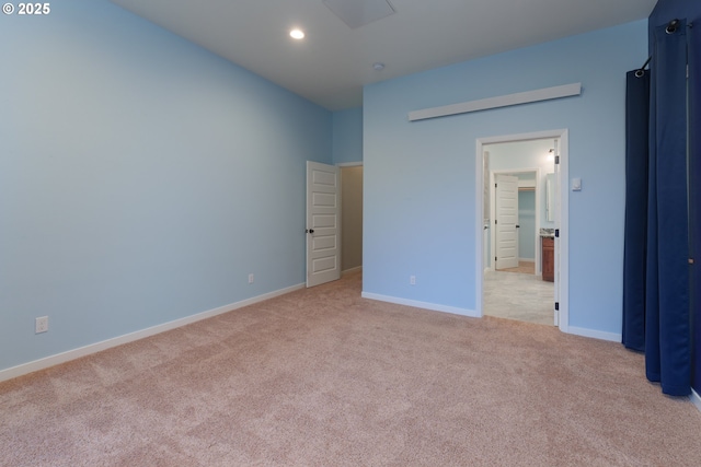 unfurnished bedroom featuring recessed lighting, baseboards, connected bathroom, and light colored carpet