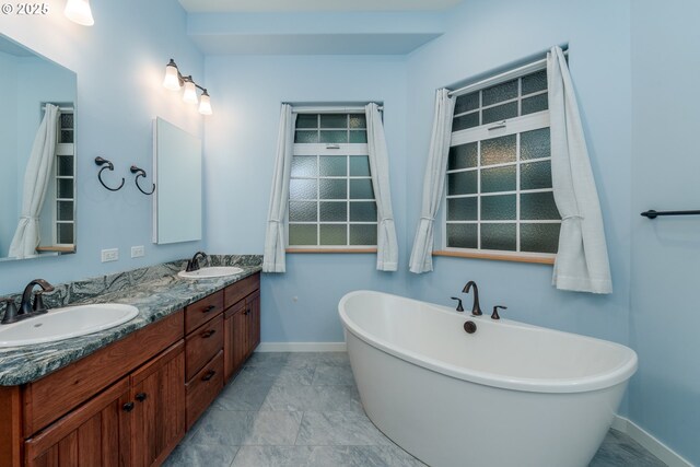 bathroom with tile patterned flooring, tiled shower, vanity, and toilet