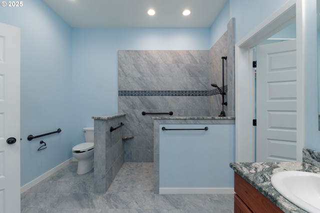 bathroom with baseboards, toilet, walk in shower, vanity, and recessed lighting