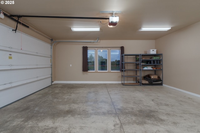 garage featuring a garage door opener and baseboards