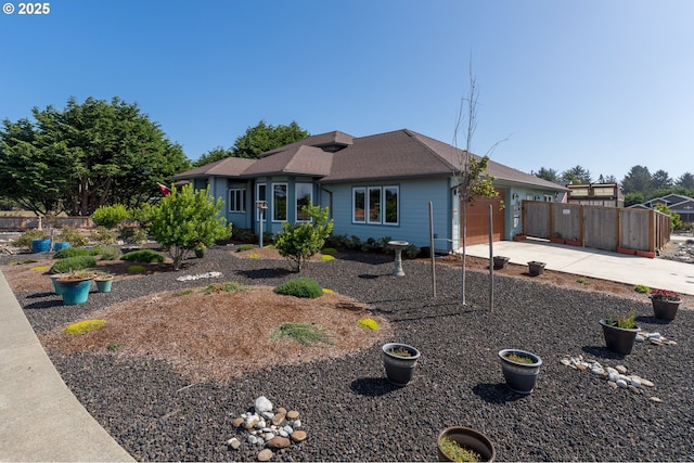 ranch-style house with a garage, driveway, and fence