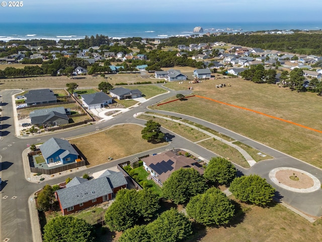 drone / aerial view with a water view and a residential view