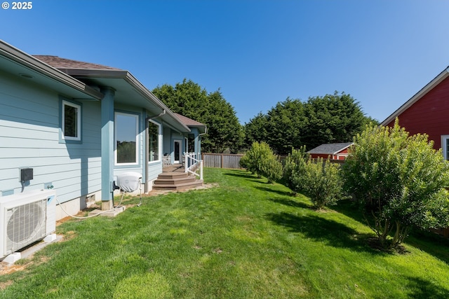 view of yard with ac unit and fence