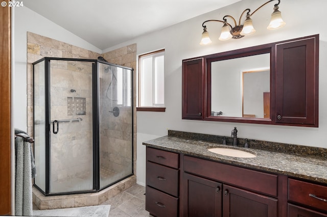 bathroom featuring vanity, vaulted ceiling, a shower with door, and tile patterned floors