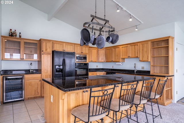 kitchen with a kitchen breakfast bar, vaulted ceiling, black appliances, beverage cooler, and sink