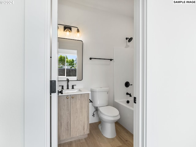 full bathroom with vanity, wood-type flooring, bathtub / shower combination, and toilet