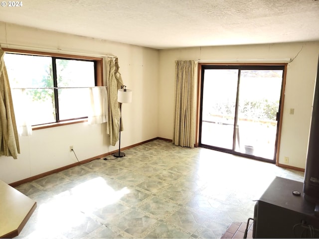 unfurnished room with a textured ceiling