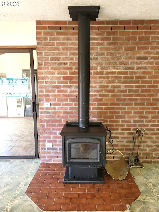 details featuring a textured ceiling and a wood stove