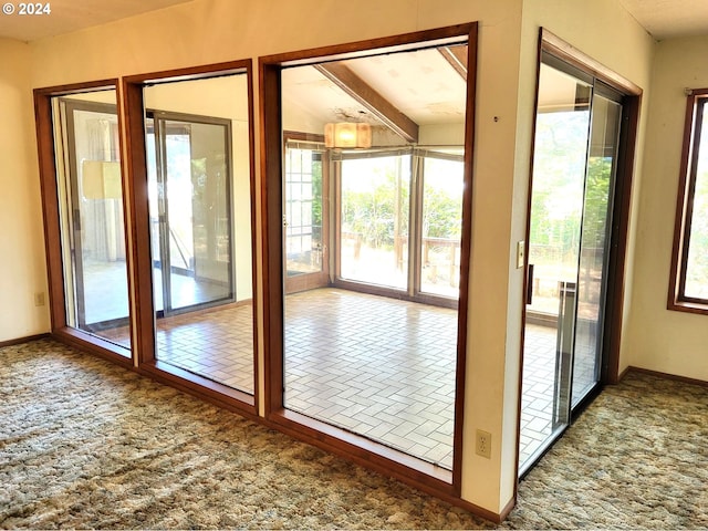 doorway to outside with lofted ceiling with beams and carpet