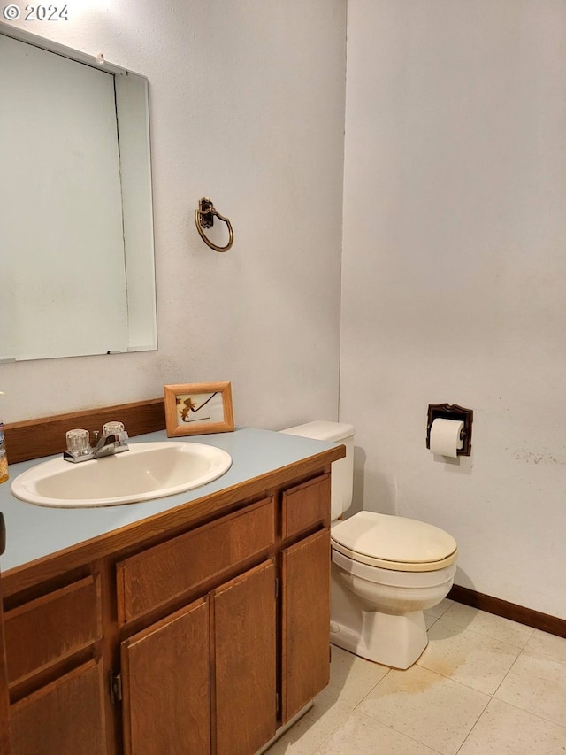 bathroom featuring vanity, toilet, and tile patterned floors