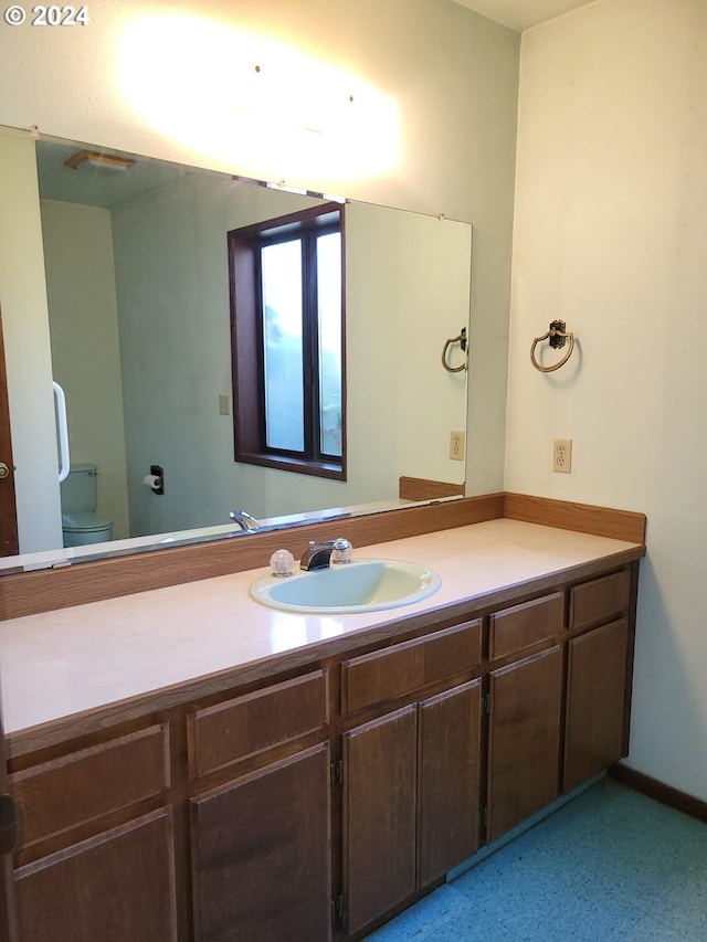 bathroom featuring vanity and toilet