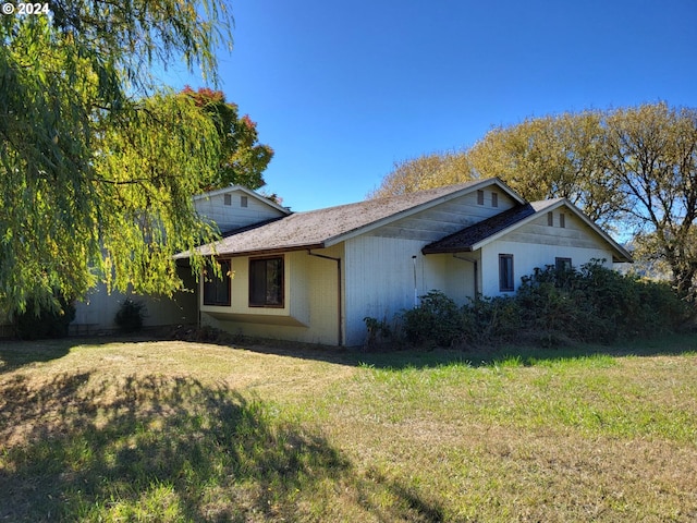 view of home's exterior with a yard