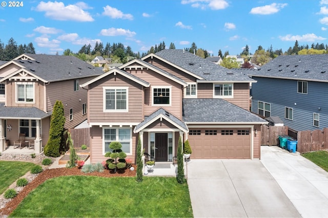 craftsman house featuring a front lawn and a garage