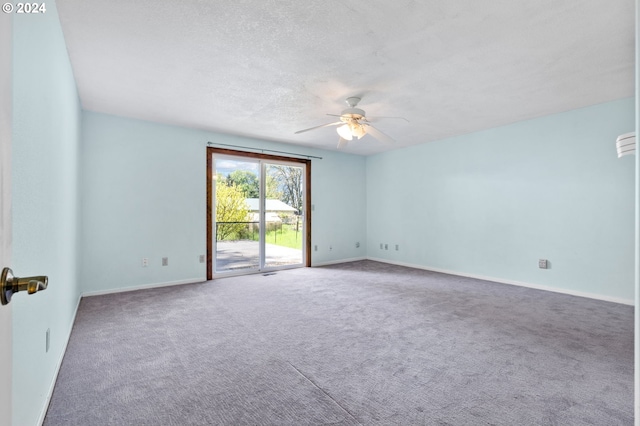 carpeted empty room with ceiling fan and a textured ceiling