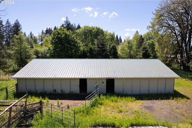 5750 SW River Rd, Hillsboro, OR 97123 - view of home's exterior with a metal roof, an outdoor structure, an exterior structure, and board and batten siding