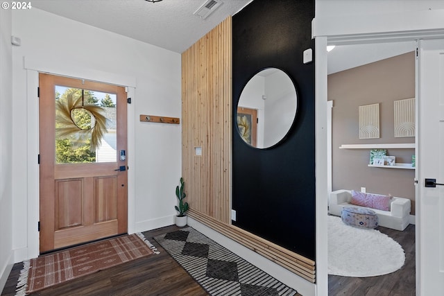 entryway with a textured ceiling and dark hardwood / wood-style flooring