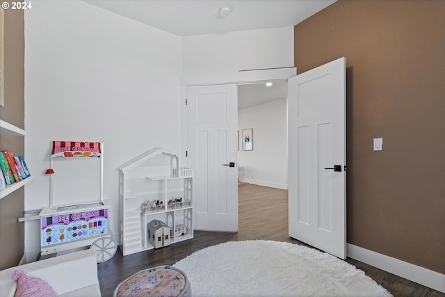 bedroom with dark hardwood / wood-style floors