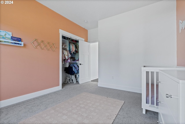 unfurnished bedroom featuring carpet flooring and a closet