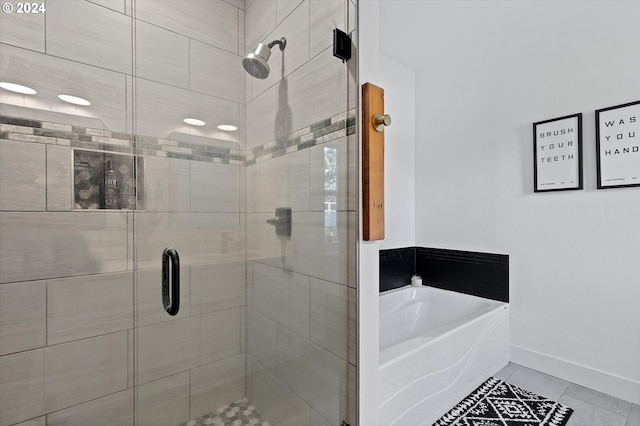 bathroom featuring tile patterned flooring and separate shower and tub