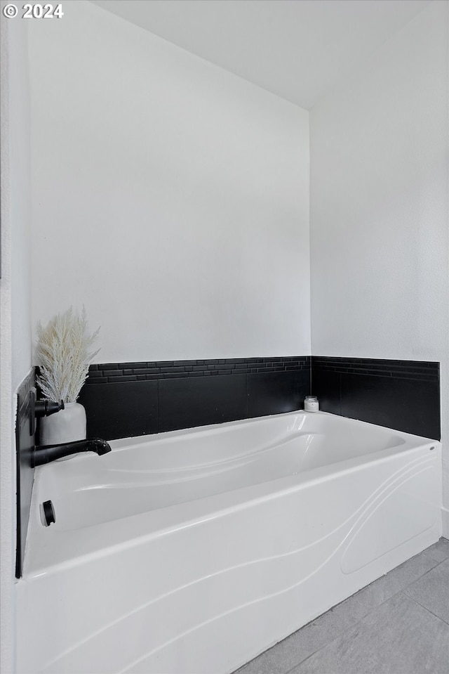 bathroom featuring tile patterned flooring and a bath