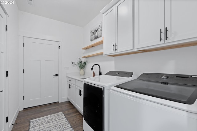 washroom with cabinets, independent washer and dryer, dark hardwood / wood-style floors, and sink