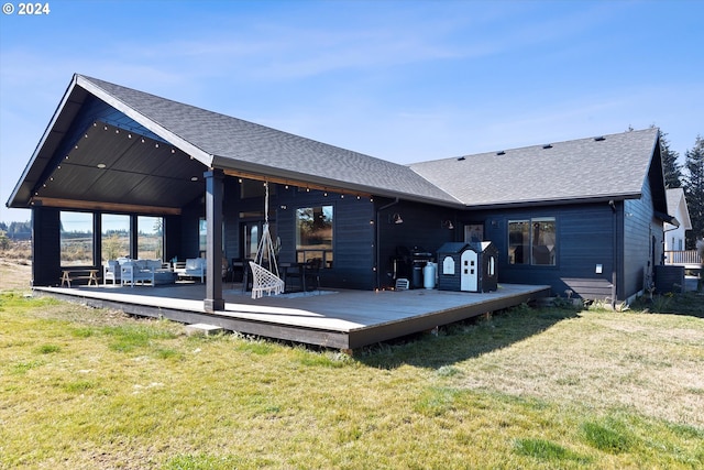 rear view of property with an outdoor hangout area, a deck, a yard, and central AC