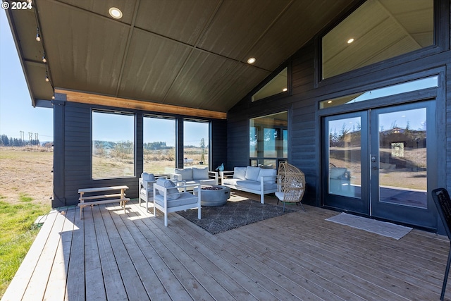 wooden terrace with french doors and an outdoor hangout area