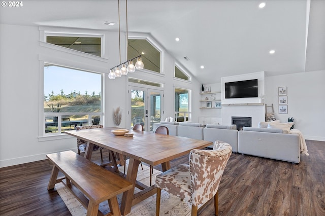 dining area with dark hardwood / wood-style floors, high vaulted ceiling, and french doors