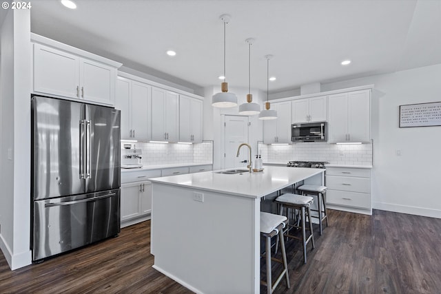 kitchen featuring dark hardwood / wood-style flooring, white cabinets, and stainless steel appliances