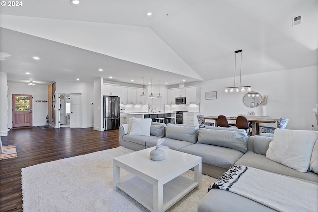 living room featuring high vaulted ceiling and hardwood / wood-style flooring