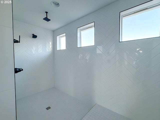 full bath with a tile shower