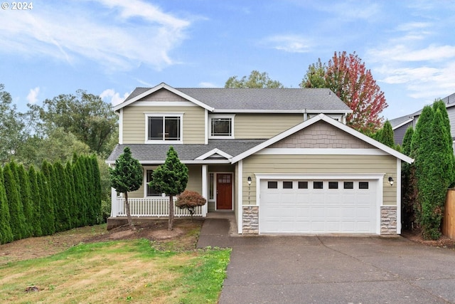 view of front of home with covered porch and a garage