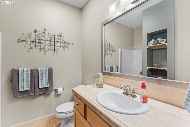 bathroom featuring a shower, tile patterned flooring, vanity, and toilet