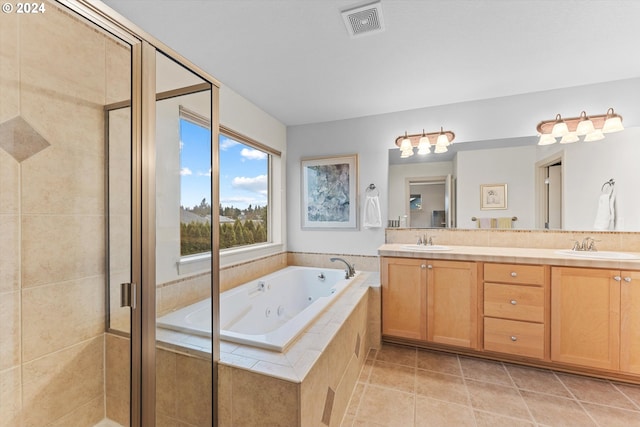 bathroom featuring tile patterned flooring, vanity, and plus walk in shower