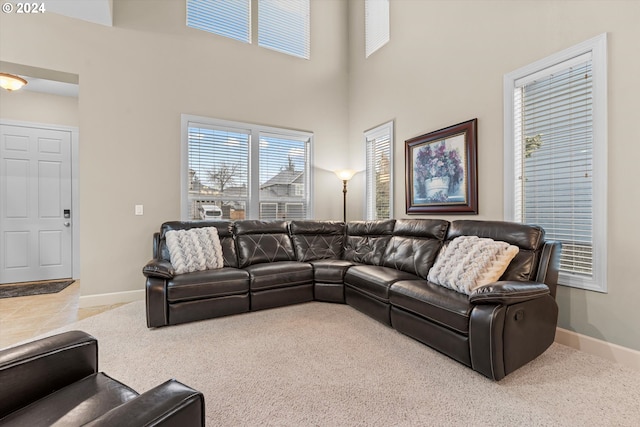 living room featuring a high ceiling and carpet floors