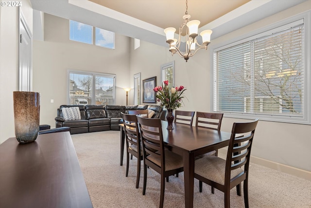 carpeted dining room featuring an inviting chandelier