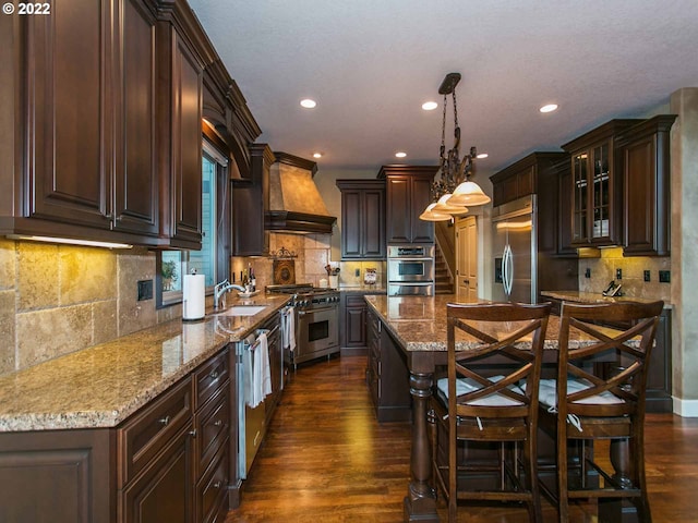 kitchen with backsplash, premium range hood, dark wood-type flooring, and high end appliances