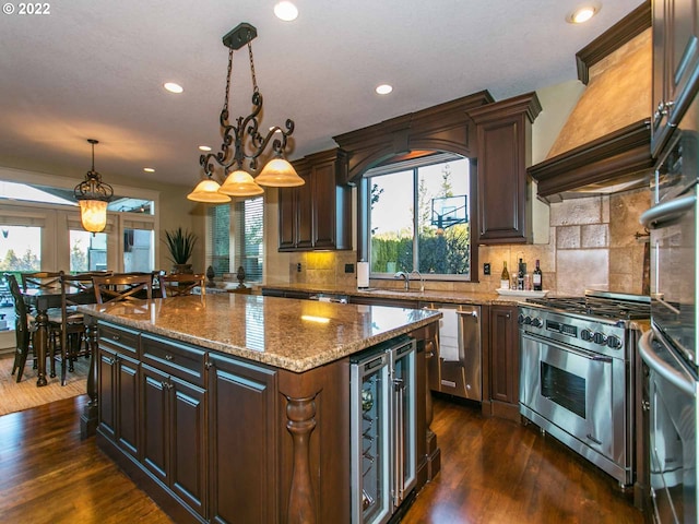 kitchen featuring backsplash, dark wood-type flooring, wine cooler, and a kitchen island