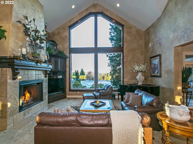 tiled living room with high vaulted ceiling and a tiled fireplace