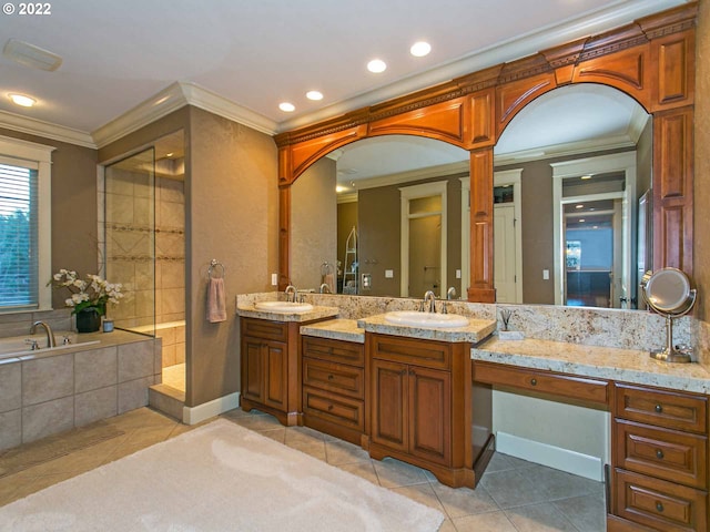 bathroom featuring tiled bath, tile patterned flooring, and vanity