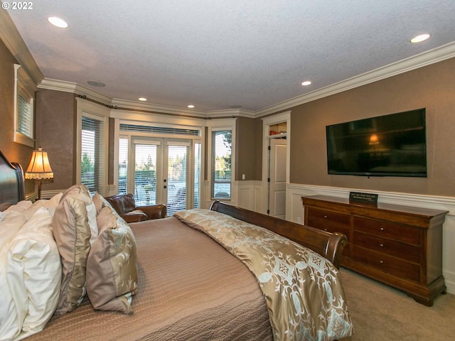 carpeted bedroom with access to outside, ornamental molding, french doors, and a textured ceiling