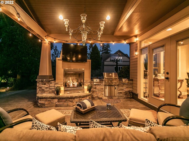 view of patio featuring an outdoor living space with a fireplace, area for grilling, and an outdoor kitchen