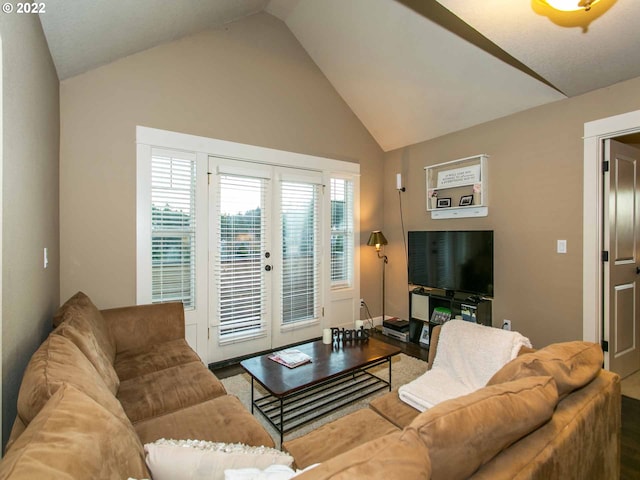 living room featuring hardwood / wood-style floors, vaulted ceiling, and french doors